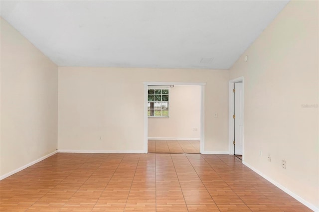 spare room with lofted ceiling