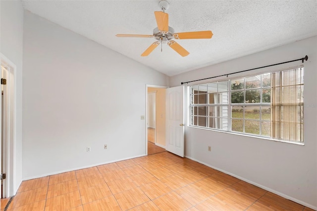 empty room with ceiling fan, a textured ceiling, and vaulted ceiling