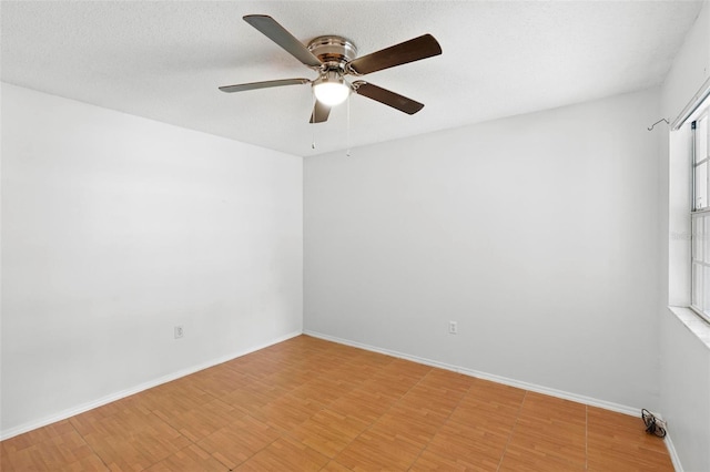 spare room featuring a textured ceiling and ceiling fan