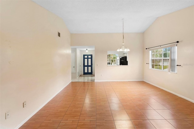 tiled spare room with a textured ceiling, high vaulted ceiling, and a notable chandelier