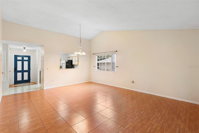 unfurnished room with light tile patterned floors, an inviting chandelier, and lofted ceiling