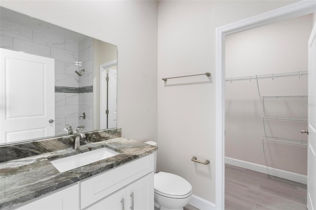 bathroom featuring vanity, toilet, and wood-type flooring