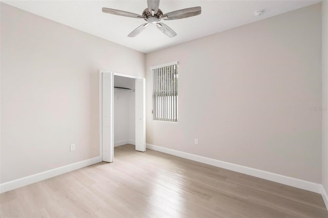 unfurnished bedroom featuring a closet, light hardwood / wood-style floors, and ceiling fan