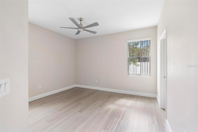 spare room with ceiling fan and light wood-type flooring