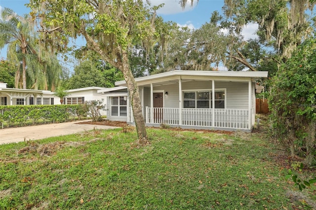 single story home featuring a front yard and covered porch