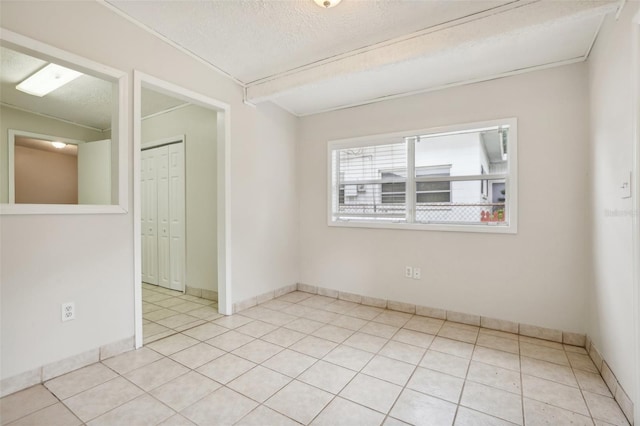 4221 Mizell St, Orlando, FL 32812 - spare room featuring light tile patterned floors, baseboards, and a textured ceiling