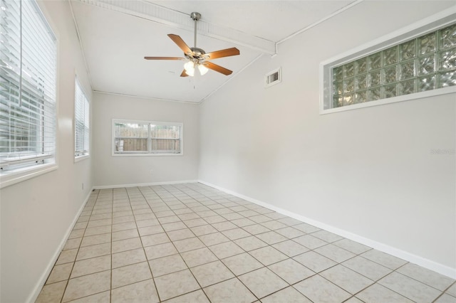 4221 Mizell St, Orlando, FL 32812 - empty room with visible vents, baseboards, ceiling fan, vaulted ceiling with beams, and light tile patterned floors