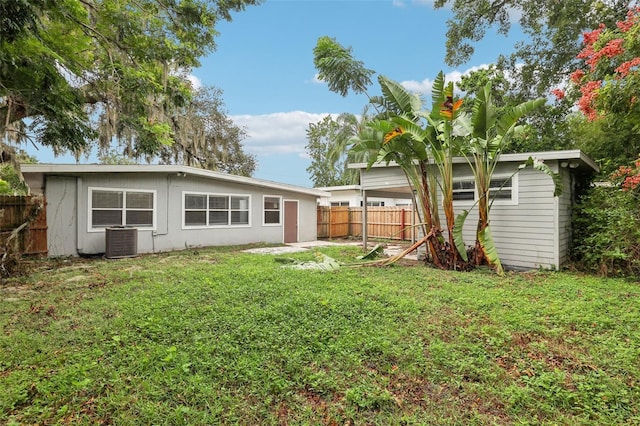 4221 Mizell St, Orlando, FL 32812 - back of property featuring fence, a yard, and cooling unit