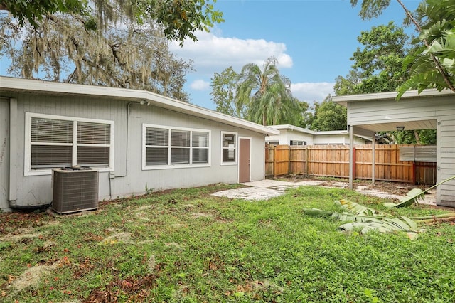 4221 Mizell St, Orlando, FL 32812 - back of property with fence, a lawn, and cooling unit