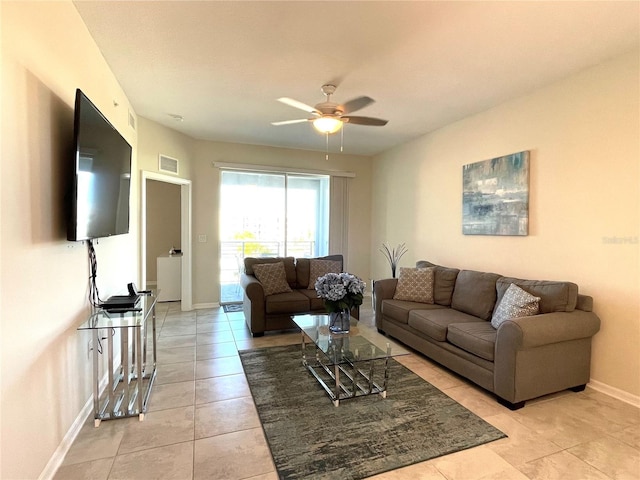 tiled living room with ceiling fan