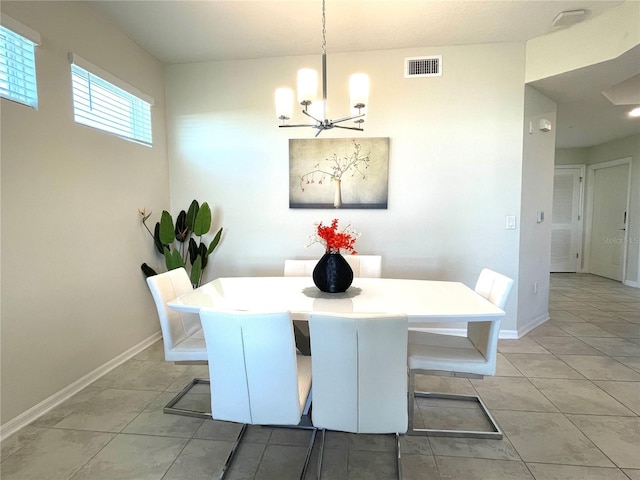 tiled dining room featuring a notable chandelier