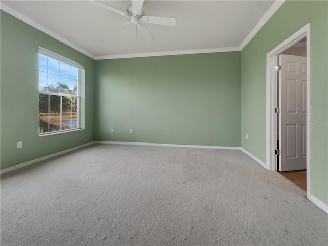 carpeted spare room with crown molding and ceiling fan