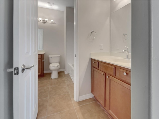 bathroom with a tub to relax in, vanity, toilet, and tile patterned floors