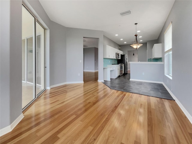 unfurnished living room featuring light wood-type flooring