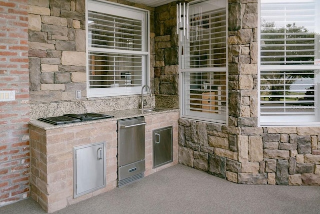 view of patio / terrace with an outdoor kitchen and sink