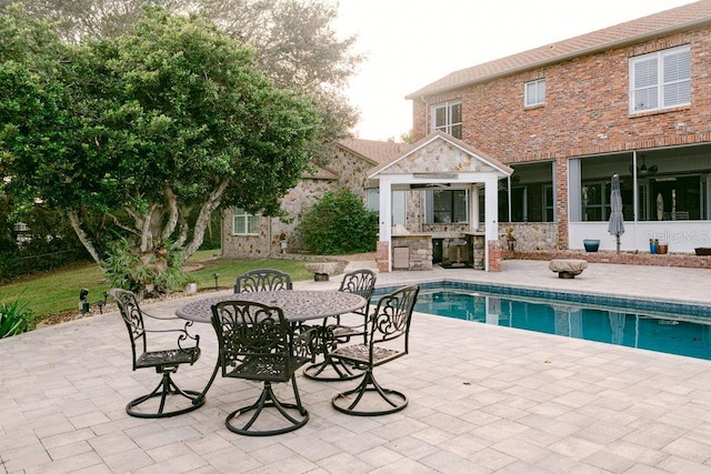 view of swimming pool featuring exterior bar and a patio