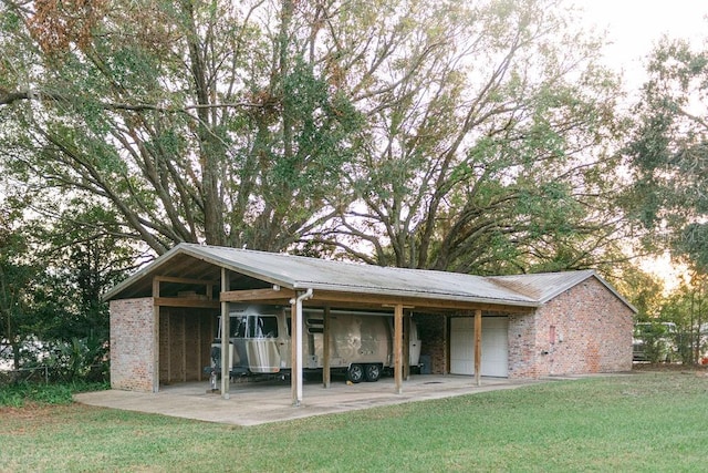 exterior space featuring a lawn and a garage