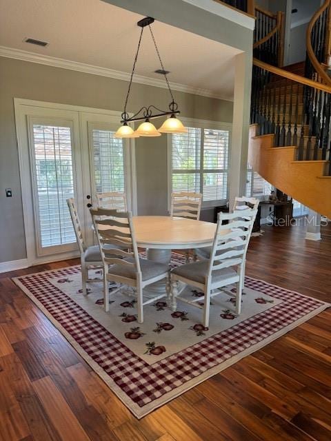 dining room featuring ornamental molding and dark wood-type flooring