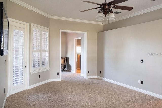 spare room featuring ceiling fan, light colored carpet, and ornamental molding