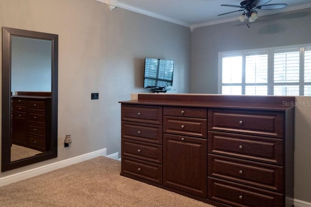 interior space with ceiling fan and crown molding