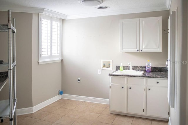 laundry area featuring electric dryer hookup, sink, crown molding, hookup for a washing machine, and light tile patterned floors