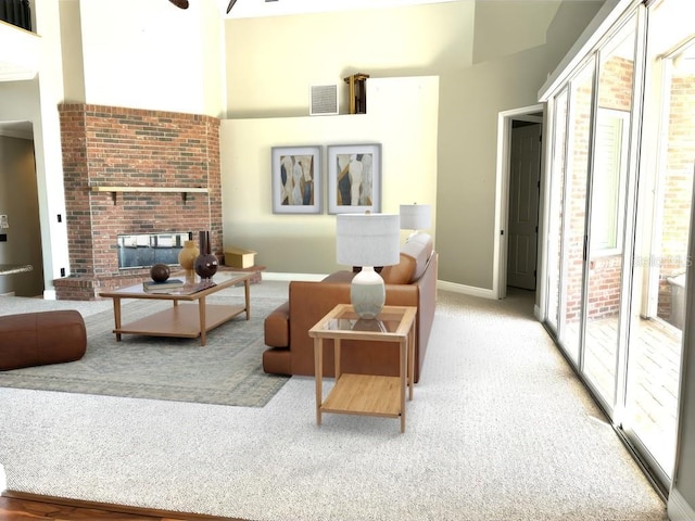 carpeted living room with a high ceiling and a brick fireplace