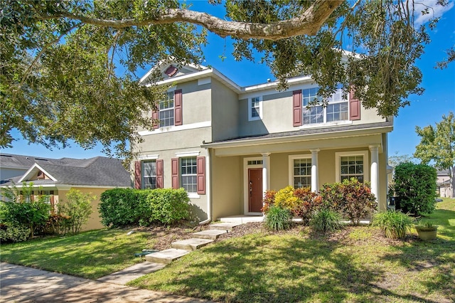 2053 Nobscot Pl, Apopka, FL 32703 - traditional home featuring a porch, stucco siding, and a front yard