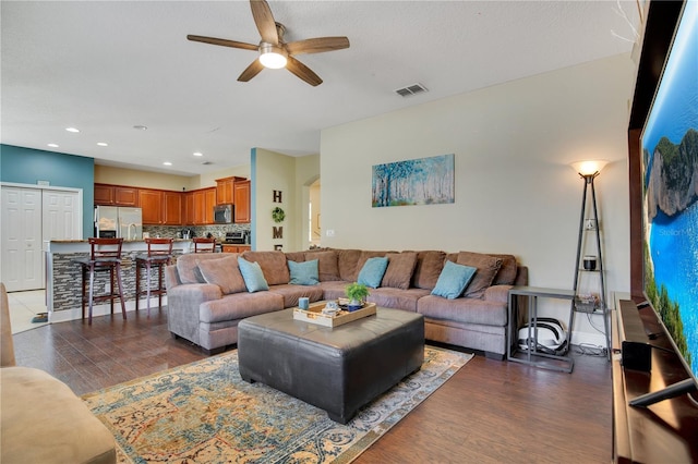 2053 Nobscot Pl, Apopka, FL 32703 - living area with a ceiling fan, arched walkways, dark wood-style floors, and visible vents