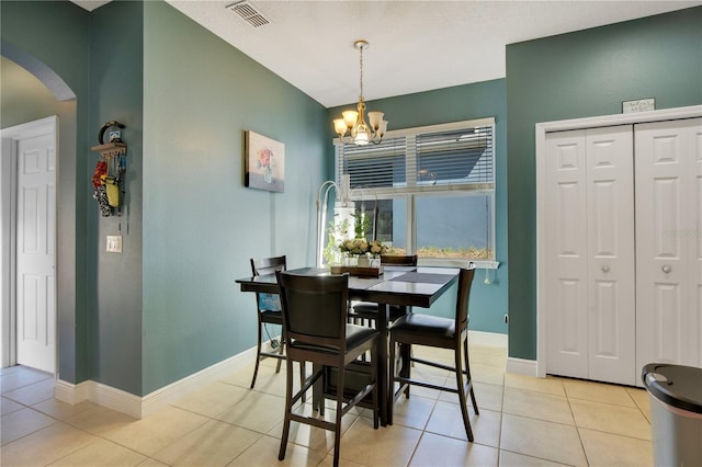 2053 Nobscot Pl, Apopka, FL 32703 - dining area with baseboards, light tile patterned floors, an inviting chandelier, visible vents, and arched walkways