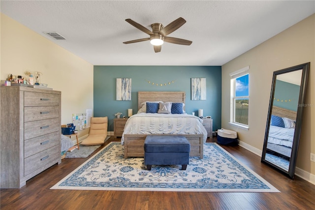 2053 Nobscot Pl, Apopka, FL 32703 - bedroom featuring a textured ceiling, dark wood-type flooring, visible vents, ceiling fan, and baseboards