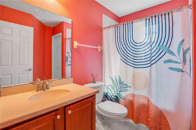 bathroom with vanity, curtained shower, and toilet