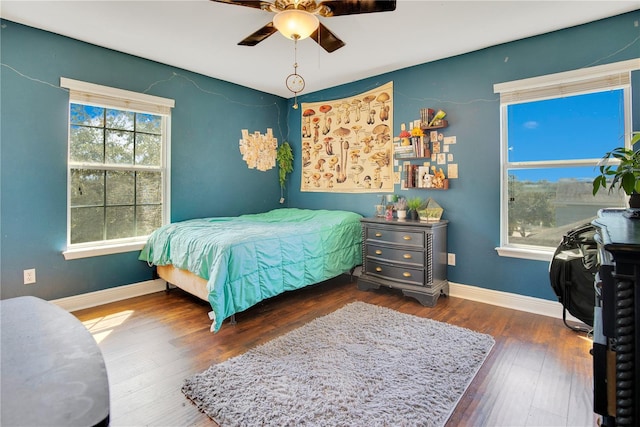 bedroom with dark wood-type flooring and ceiling fan