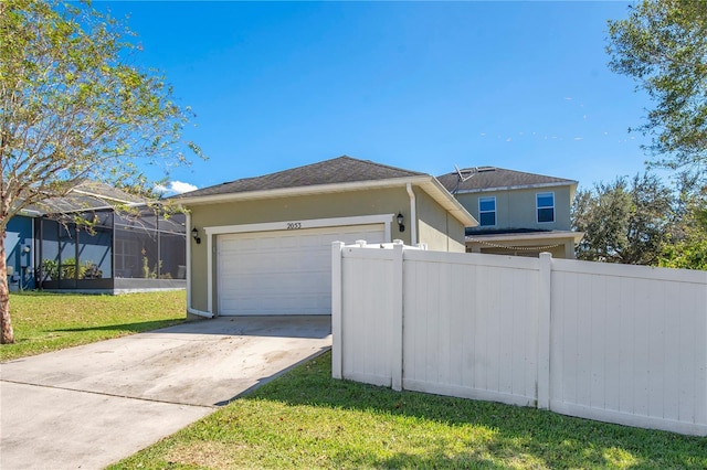 2053 Nobscot Pl, Apopka, FL 32703 - view of home's exterior with fence, an attached garage, driveway, stucco siding, and a lawn