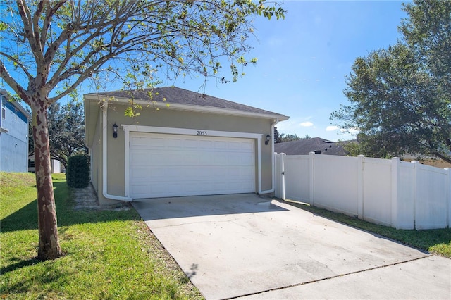 garage featuring a lawn