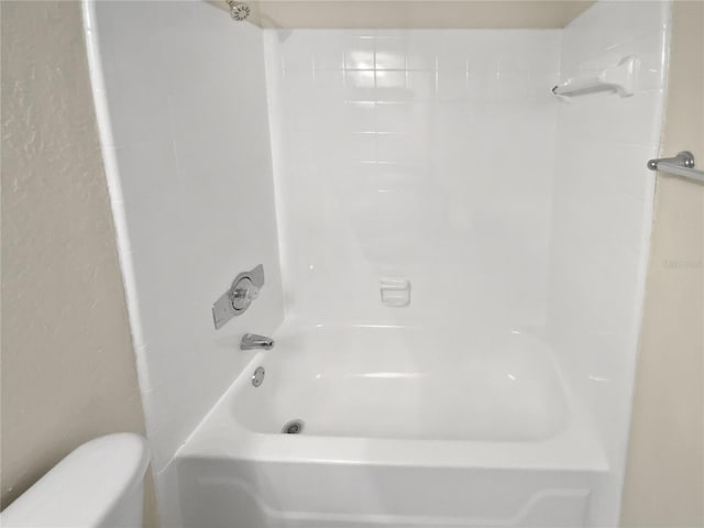 bathroom with toilet and tub / shower combination