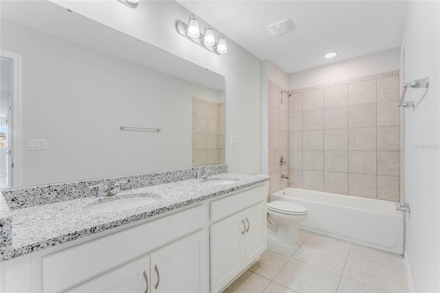 full bathroom with toilet, tiled shower / bath combo, vanity, and tile patterned flooring