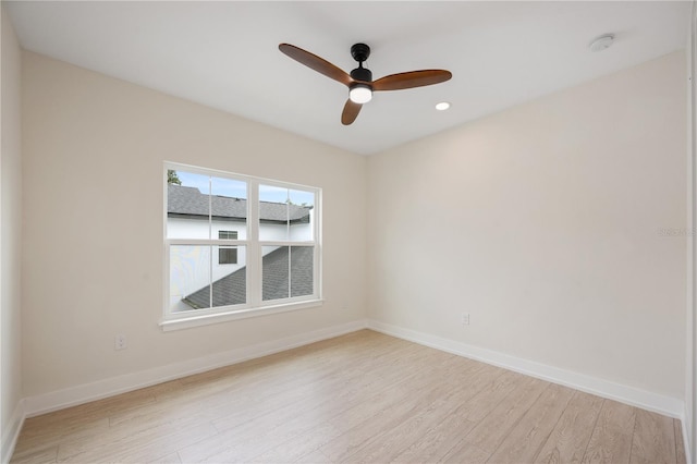 spare room featuring recessed lighting, baseboards, light wood-style floors, and a ceiling fan