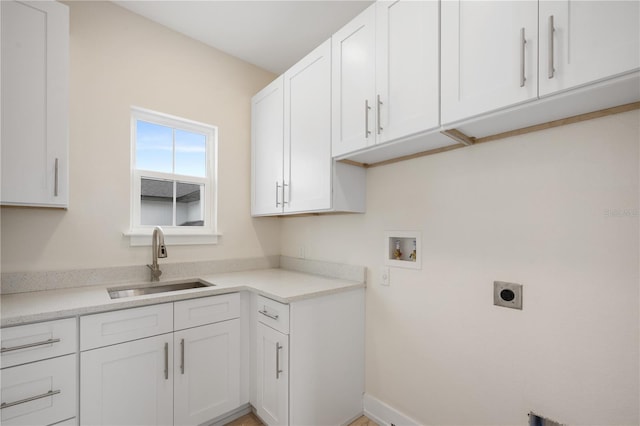 clothes washing area featuring cabinet space, hookup for an electric dryer, washer hookup, and a sink