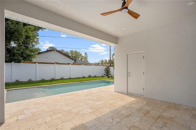 view of pool with a fenced in pool, a fenced backyard, a ceiling fan, and a patio area