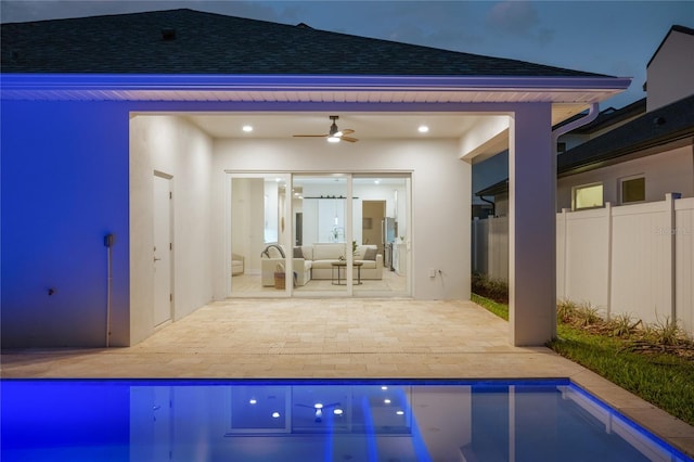 pool with outdoor lounge area, a patio area, fence, and ceiling fan