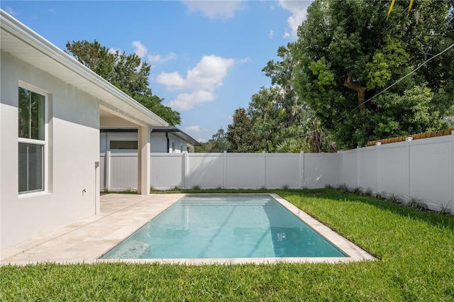 view of swimming pool featuring a fenced in pool, a lawn, a fenced backyard, and a patio area