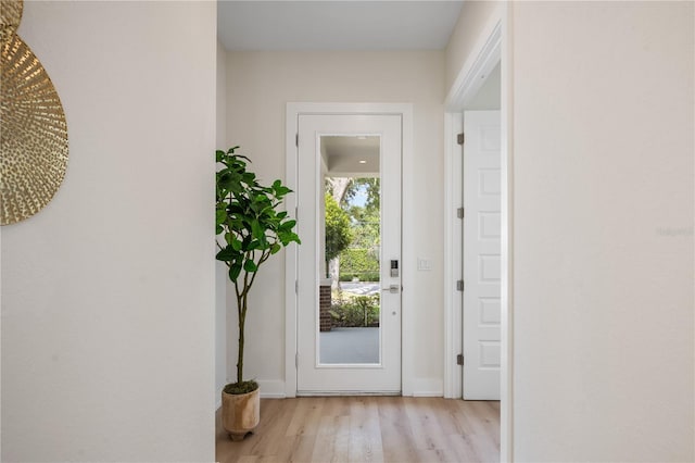 doorway to outside with light wood finished floors