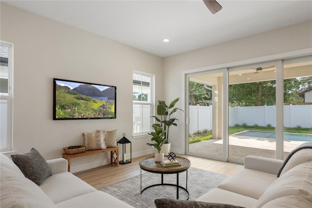 living room featuring recessed lighting, light wood-style flooring, baseboards, and a ceiling fan