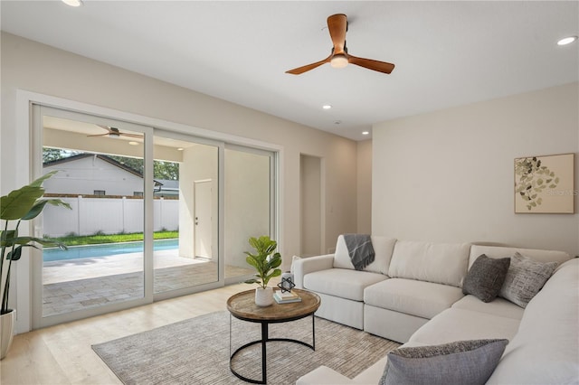 living room featuring recessed lighting, a ceiling fan, and light wood finished floors