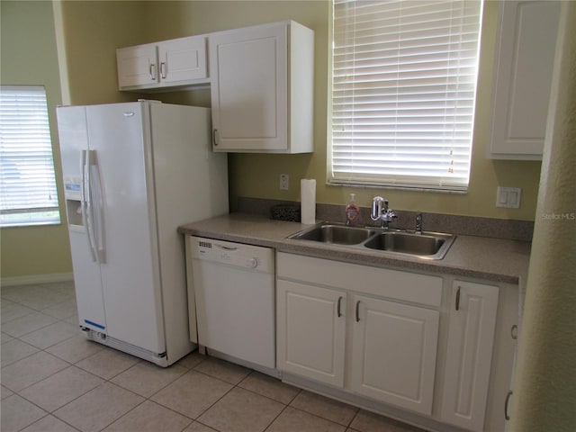 kitchen with a healthy amount of sunlight, sink, white cabinets, and white appliances