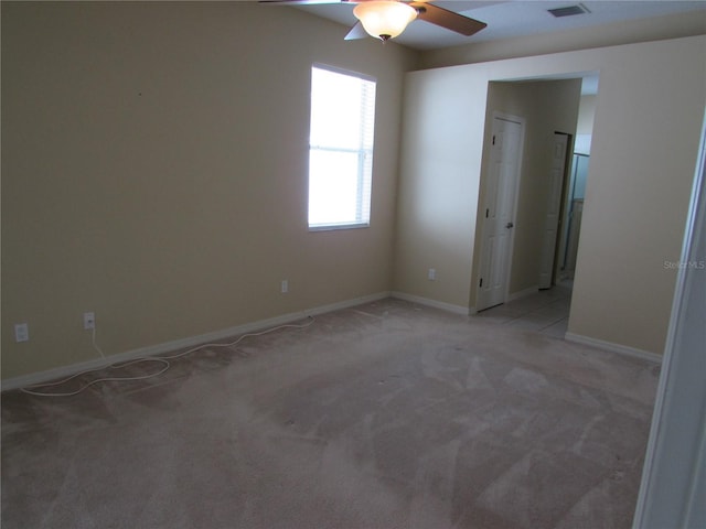 carpeted spare room featuring ceiling fan