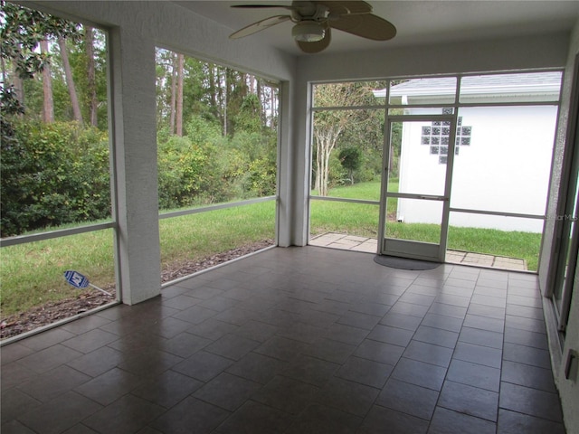 unfurnished sunroom featuring ceiling fan