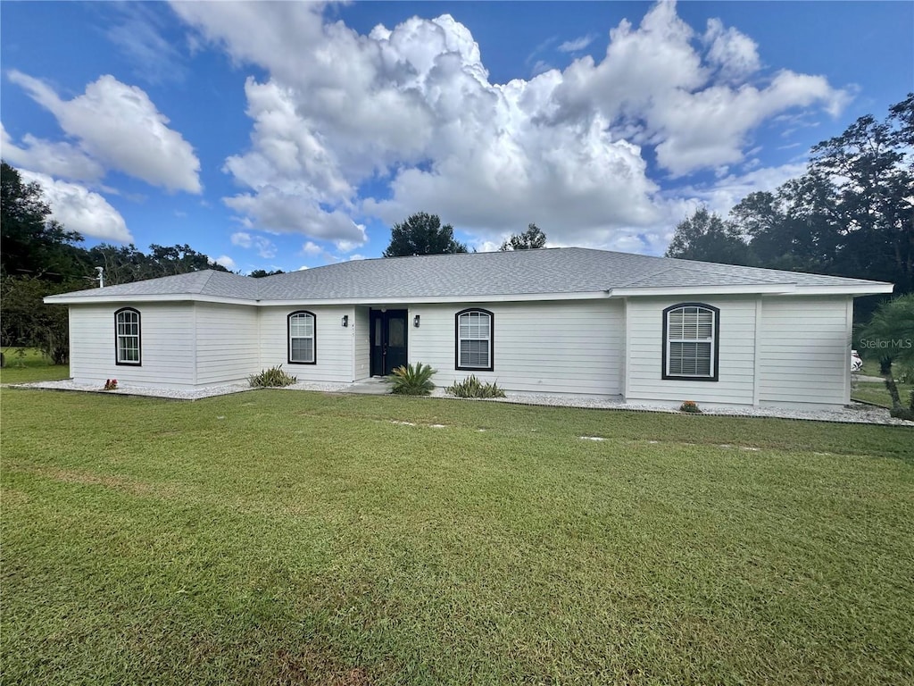 ranch-style home with a front lawn