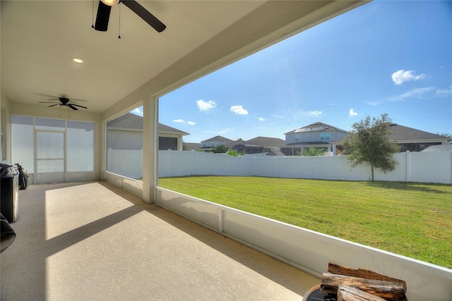 unfurnished sunroom with ceiling fan and a wealth of natural light