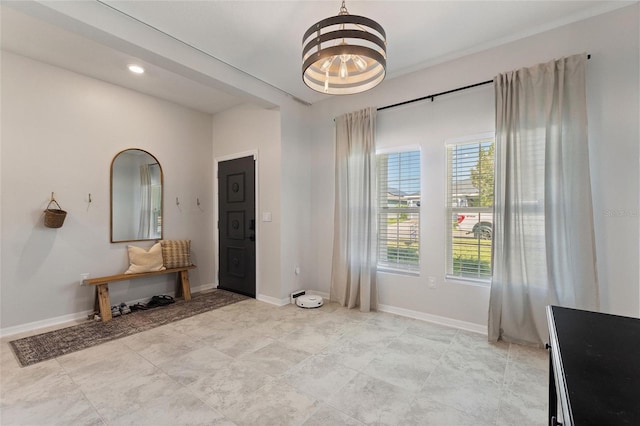 foyer entrance featuring a notable chandelier